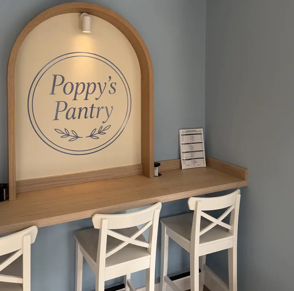 Poppy's Pantry sign worktop with high stools